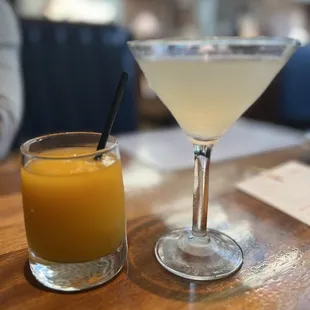 a glass of orange juice next to a glass of orange juice