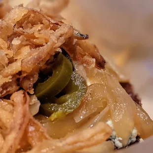 Close up of the build your own burger with lots of stuff. Stuff tastes good.