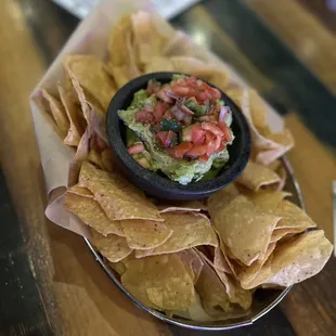 a bowl of guacamole and chips