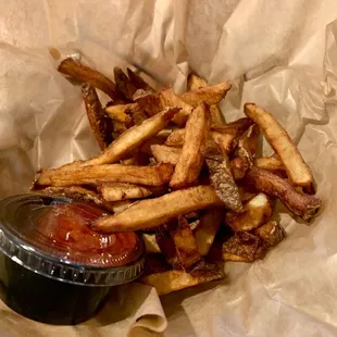 a basket of french fries with ketchup