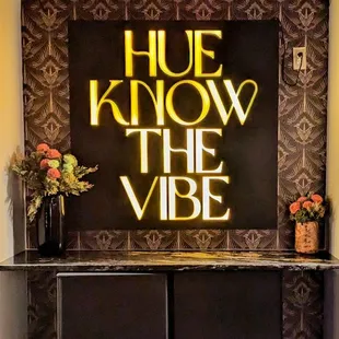 a sign that reads hue know the vibe