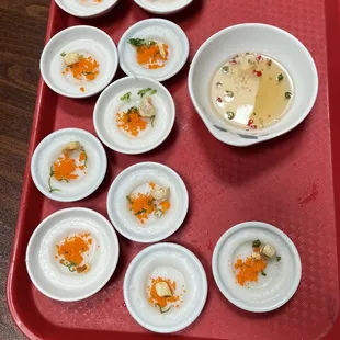 a tray of small bowls of food