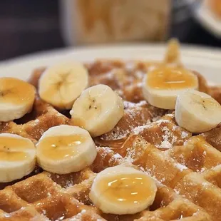 Belgium, waffle with fresh banana slices and caramel drizzle