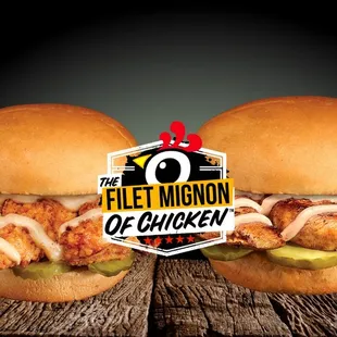 two chicken tenders and a pickle on a bun