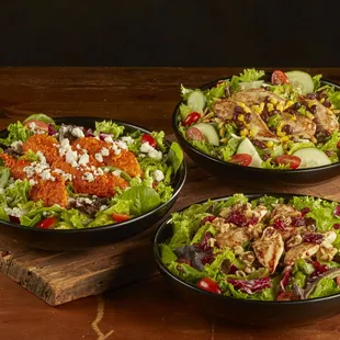 three bowls of salad