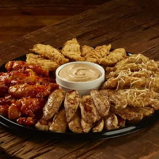 a platter of chicken tenders with sauce