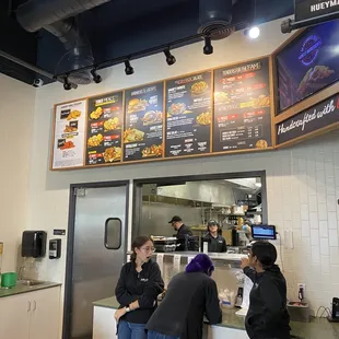 Menu Board with the latest prices....they charge xtra now to toss your Chicken in the sauce!!!