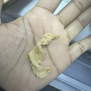 Chewy chicken skin In my wrap. They don't clean and prep their chicken properly