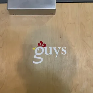 Men&apos;s room with giant head shadow.