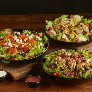 three bowls of salad