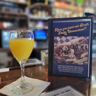a glass of beer and a menu