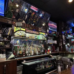 a view of the bar and televisions