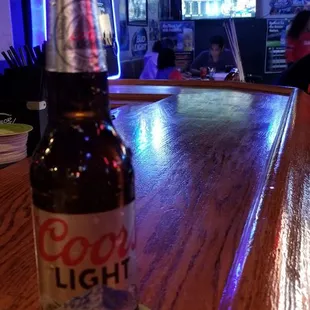 a bottle of beer on a bar