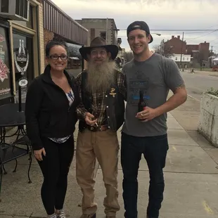 a man with a long beard and a woman standing next to him