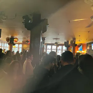 a crowd of people in a bar