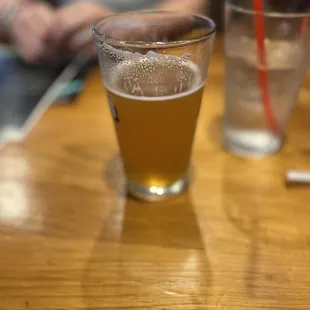 a glass of beer on a table