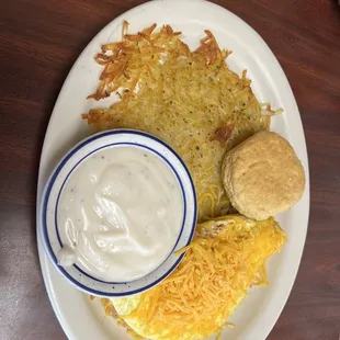 Ham and cheese omelette, hash browns and biscuit w/ gravy