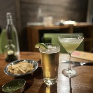 a glass of beer and a plate of crackers