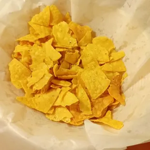 A bowl of complimentary chip pieces. Each bowl of chips came with at least half of them crushed.