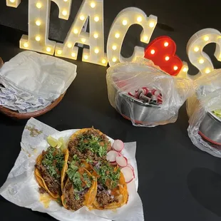 two tacoss on a table