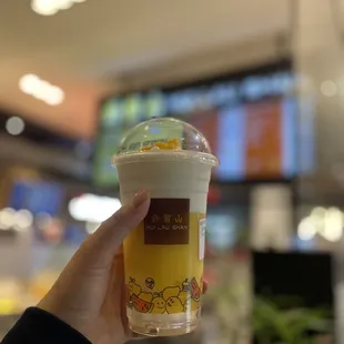 a hand holding a cup of coffee