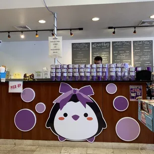 a penguin with a purple bow