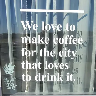 a sign in the window of a coffee shop