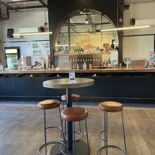 a bar with stools and tables