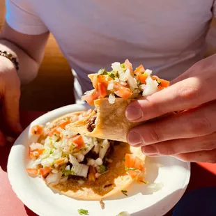 a person holding a taco