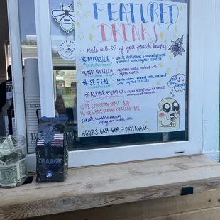 a sign in the window of a coffee shop