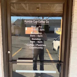 a man standing in front of a coffee shop