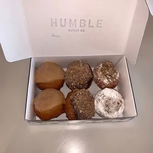 From left to right: churro, Twix, alfajor (coconut/ pecan) mini donuts