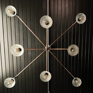 a circular chandelier with eight lamps