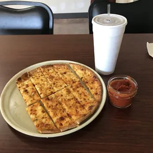 a plate of pizza and a cup of coffee