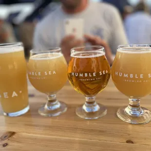 three glasses of beer on a table