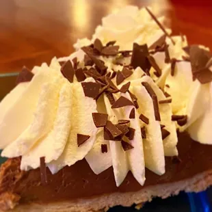  a chocolate pie with whipped cream and chocolate sprinkles