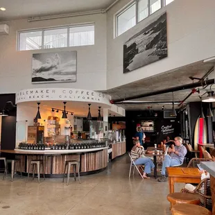 people sitting at tables in a coffee shop