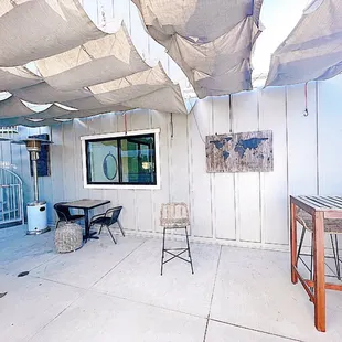 a patio with a table and chairs