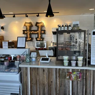 a coffee shop counter with a variety of drinks