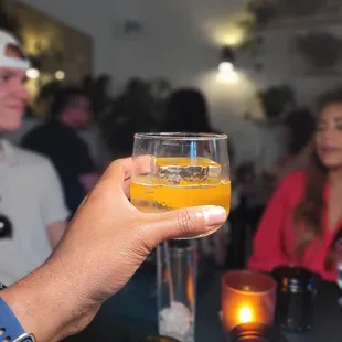 a person holding a glass of beer