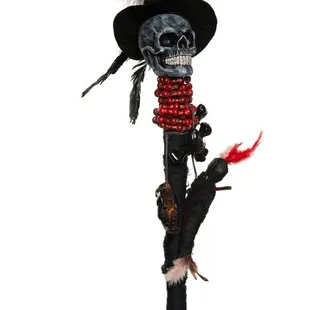 Staff w/ skull wearing a hat. Beads and feathers attached to staff
