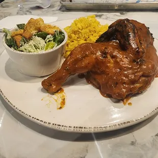Half-chicken, seasoned rice, side caesar
