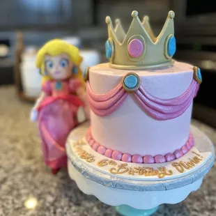 a cake with a princess figurine on top