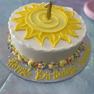 a birthday cake with a sun on top