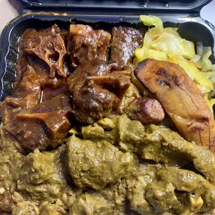 Curry goat and oxtail large combo with a side of rice and peas, cabbage and fried sweet plantains