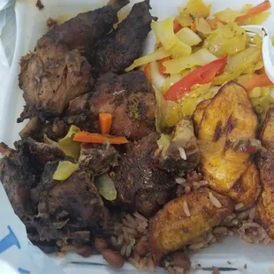 Jerk chicken dinner.  With rice and beans, cabbage and plantains.