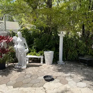 a statue of a woman sitting on a bench
