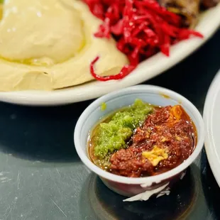 a plate of hummus and a bowl of hummus