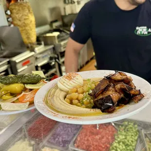 a man holding a plate of food