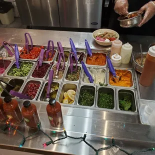 Topping options and sauce bottles in the ordering line